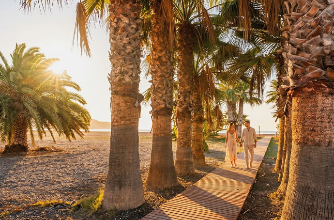 Pareja paseando por la costa tropical